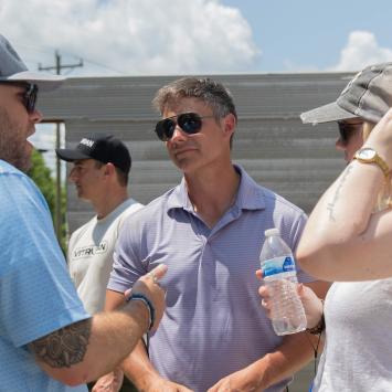 Eric Wooldridge, center, talks with visitors who gathered in June to watch the construction of Kentucky’s first 3D-printed house. The event drew a wide array of attendees, including architects, engineers, students, builders, elected officials and members of the media.